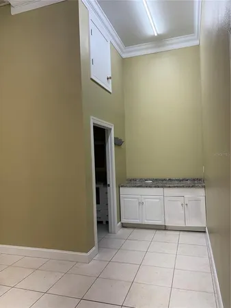 a white toilet sitting next to a white sink and vanity