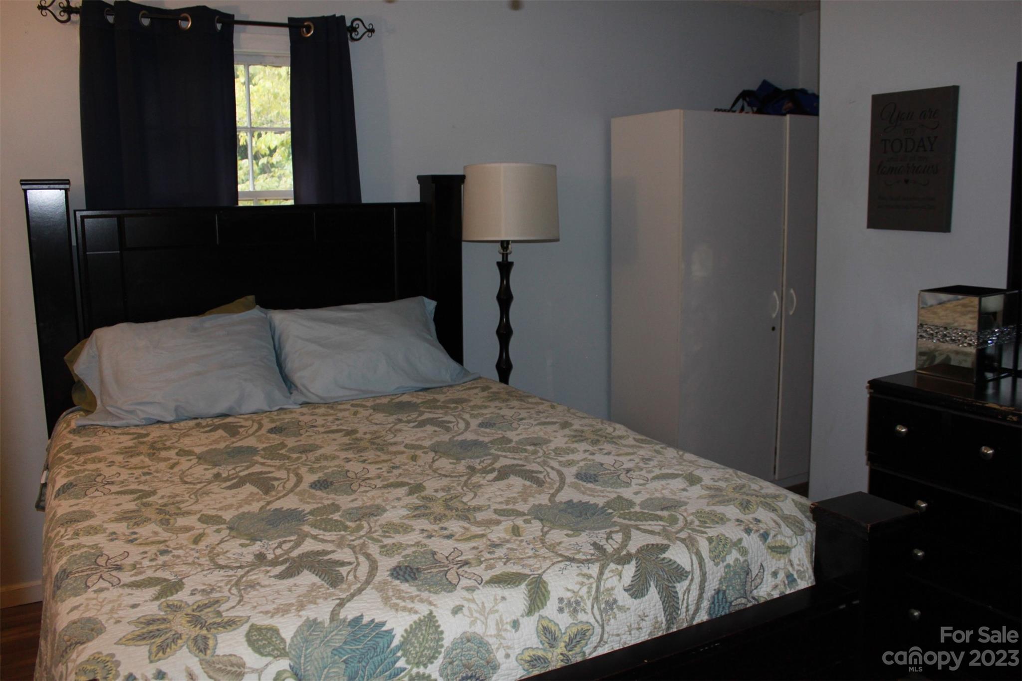 901 Coopers Gap Road Rutherfordton, NC 28139 - Photo 19 of 47 a bedroom with a bed and a lamp on table