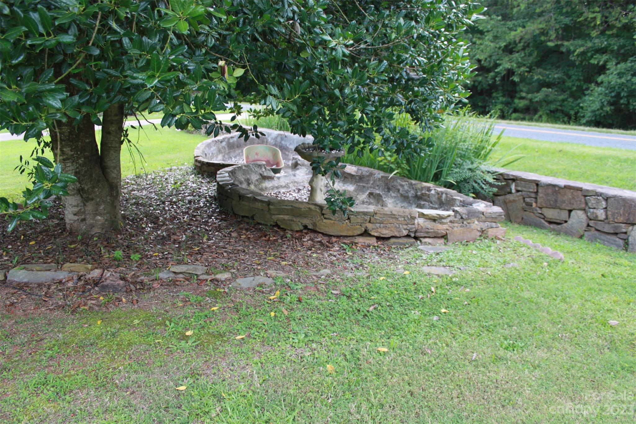 901 Coopers Gap Road Rutherfordton, NC 28139 - Photo 41 of 47 a view of a backyard with table and chairs plants and large trees