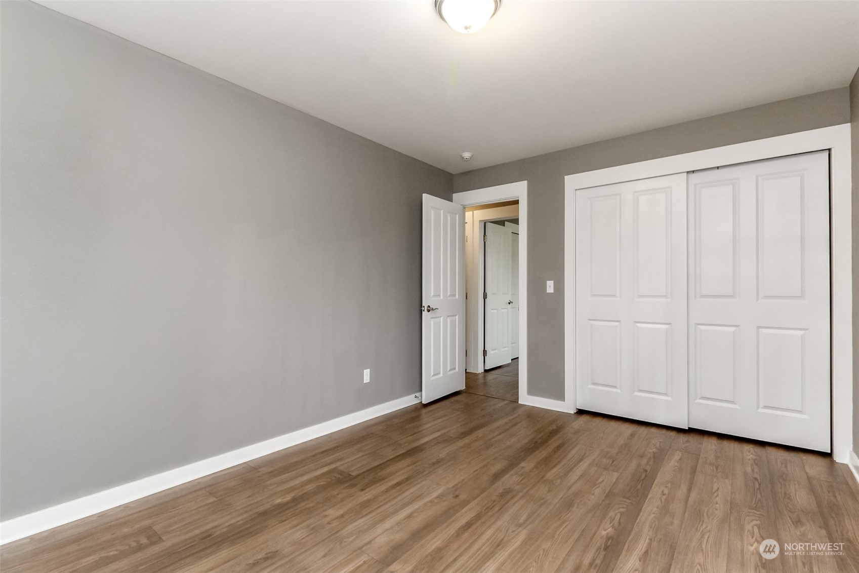 3924 Gay Road East Tacoma, WA 98443 - Photo 16 of 38 a view of an empty room with wooden floor