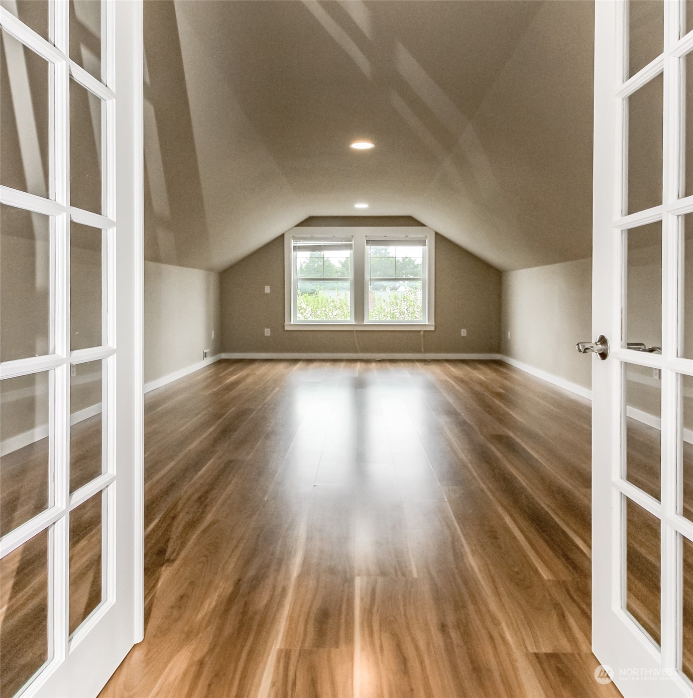 3924 Gay Road East Tacoma, WA 98443 - Photo 23 of 38 a view of an empty room with wooden floor and a window