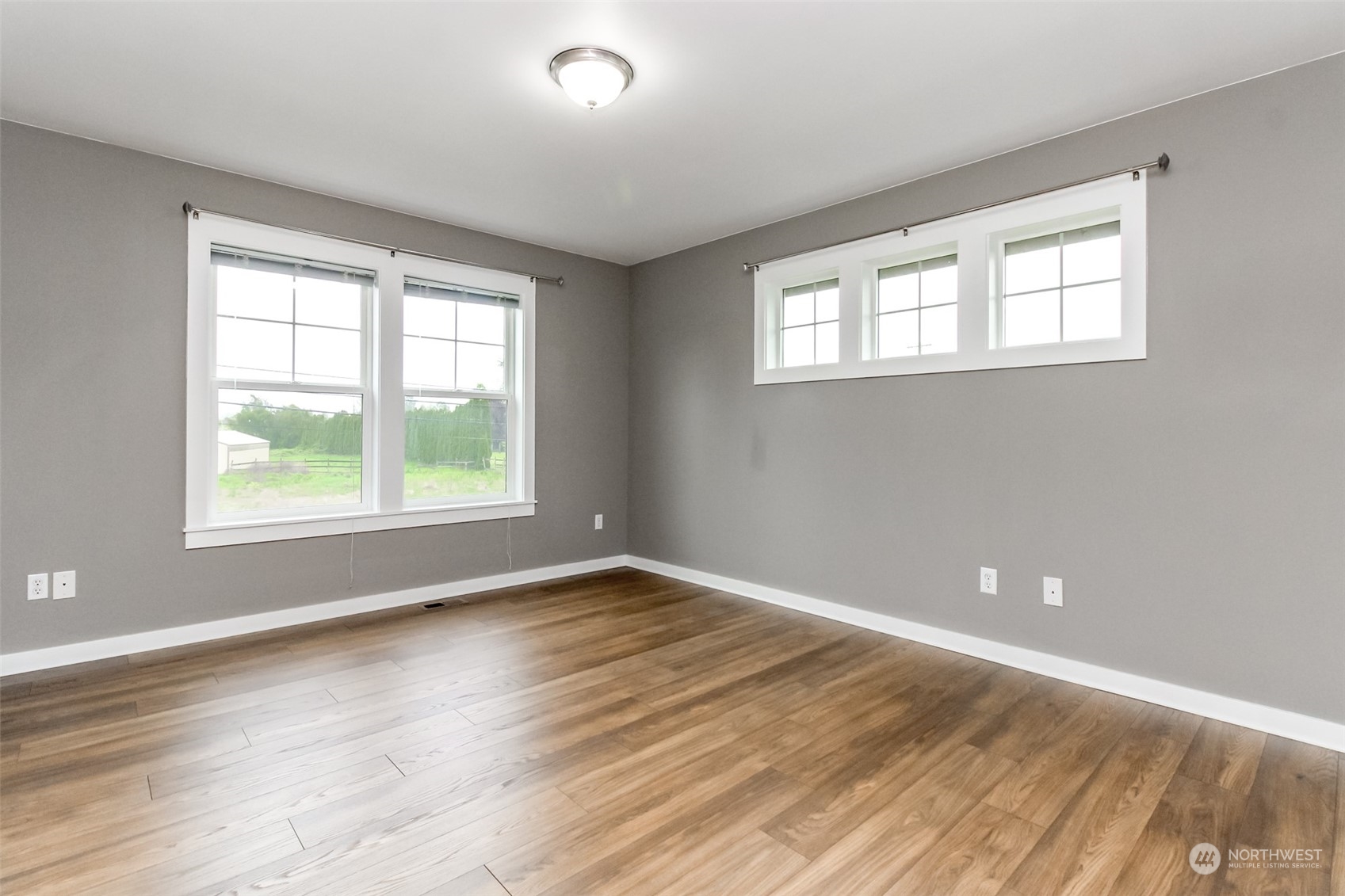 3924 Gay Road East Tacoma, WA 98443 - Photo 24 of 38 a view of an empty room with wooden floor and a window
