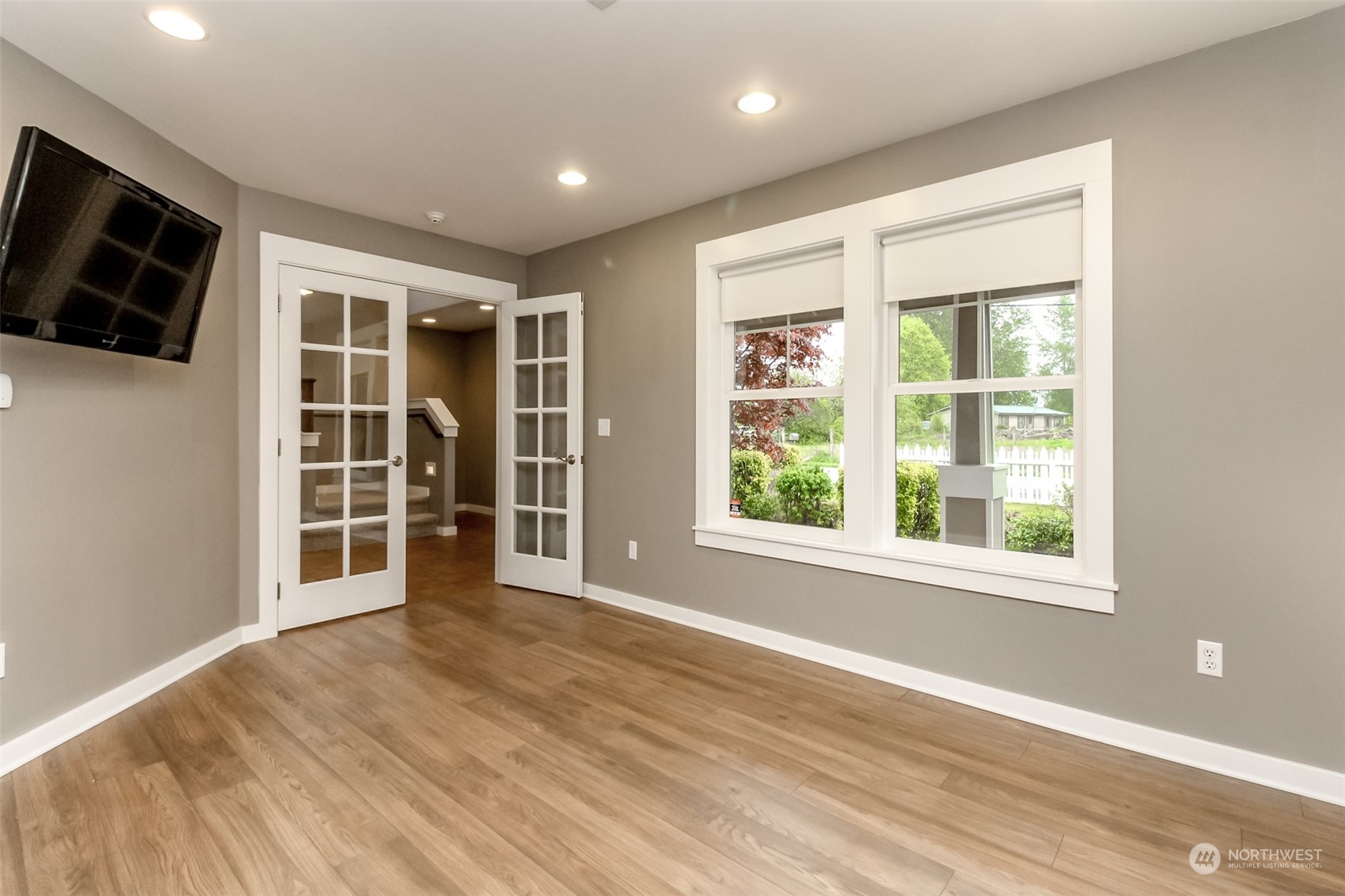 3924 Gay Road East Tacoma, WA 98443 - Photo 7 of 38 a view of an empty room with a window and wooden floor
