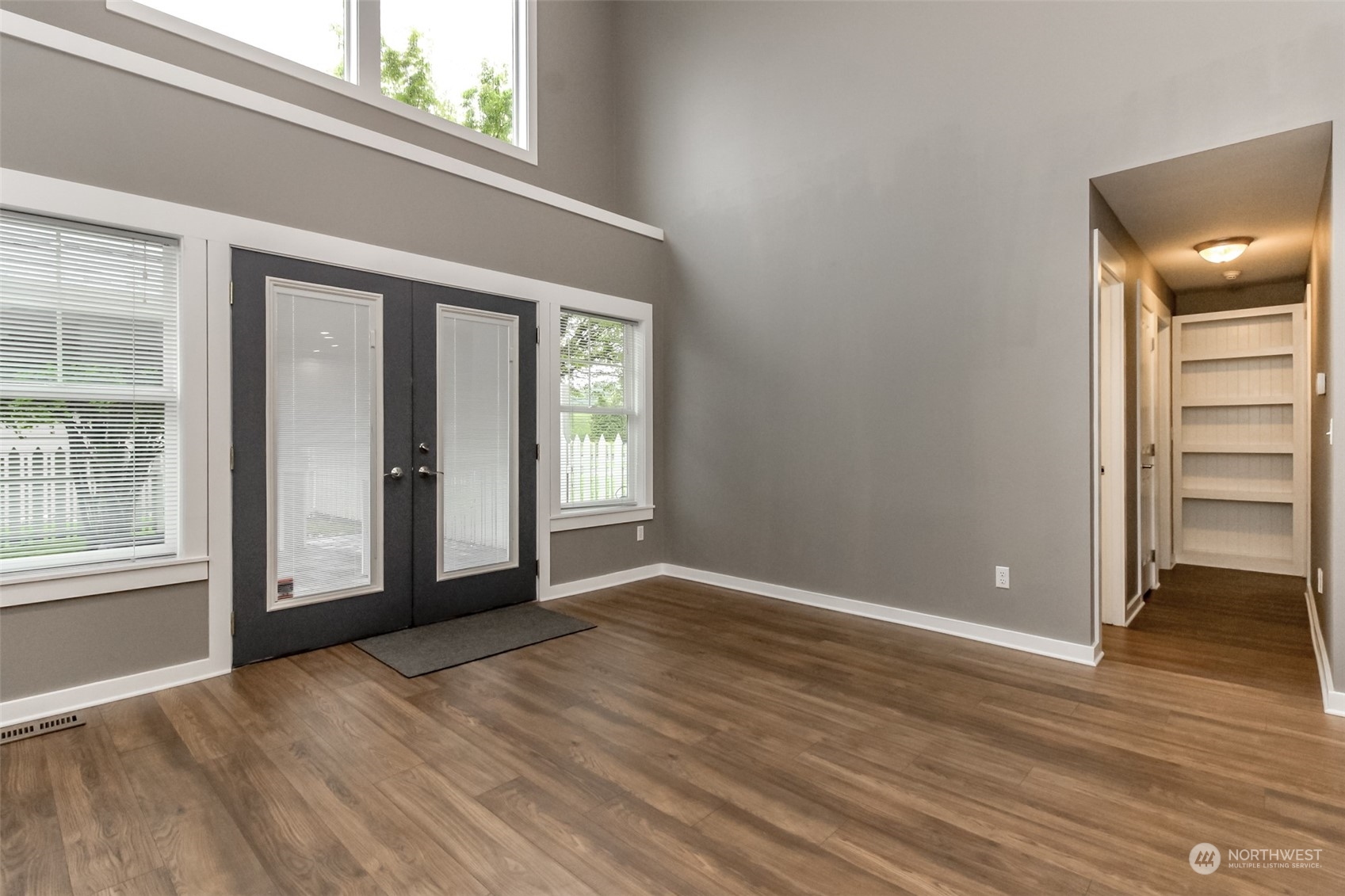 3924 Gay Road East Tacoma, WA 98443 - Photo 10 of 38 an empty room with wooden floor and windows