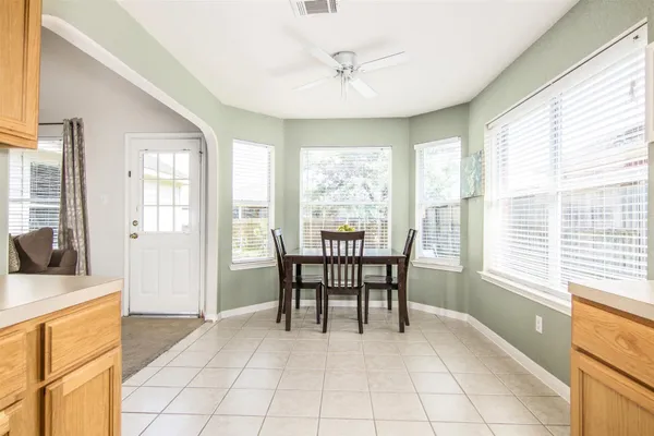 a dining room with furniture and window