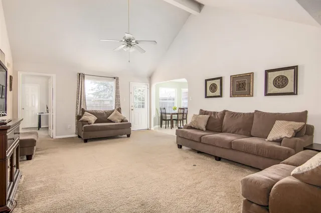 a living room with furniture and a mirror