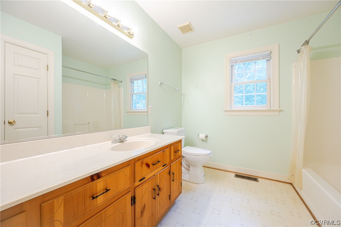 3207 Ludgate Road Chester, VA 23831 - Photo 20 of 44 a bathroom with a sink a toilet and a large mirror