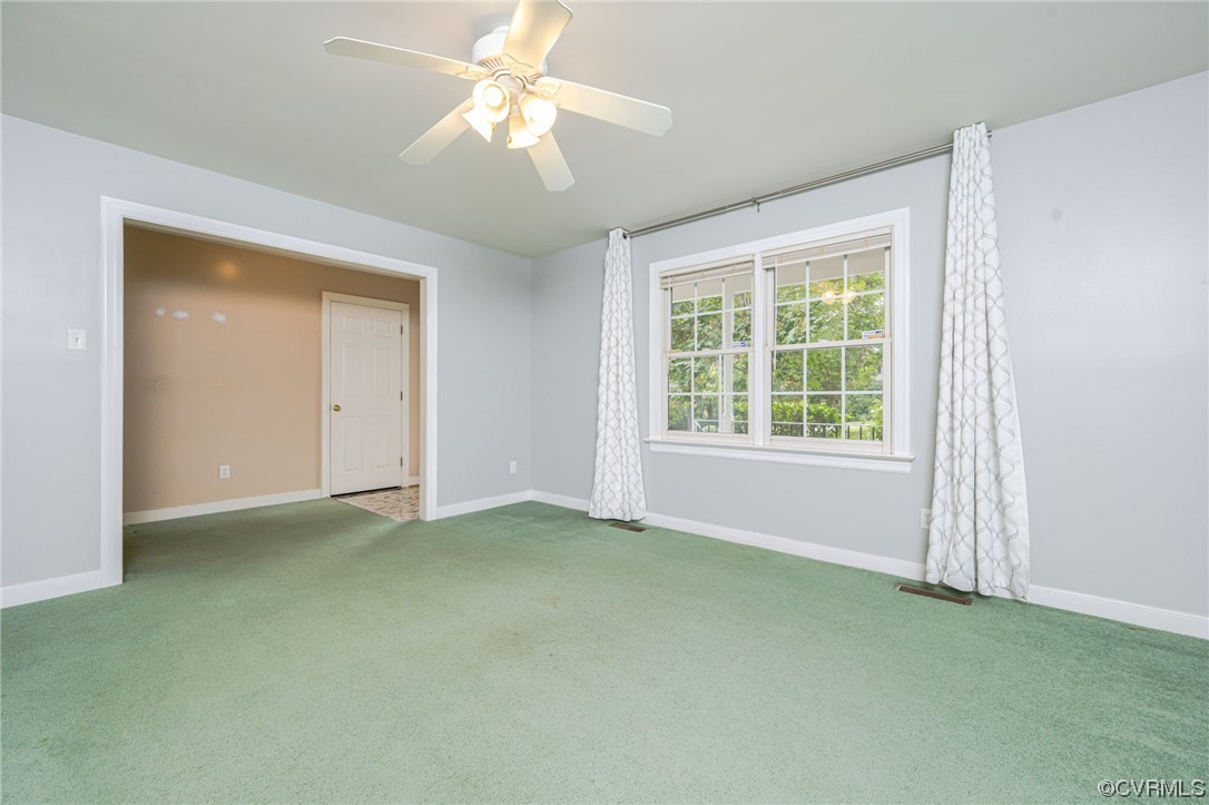3207 Ludgate Road Chester, VA 23831 - Photo 6 of 44 an empty room with chandelier fan and windows