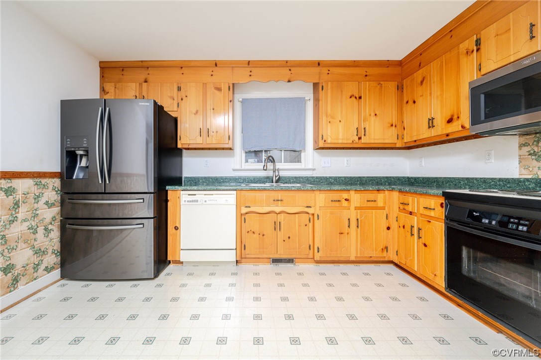 3207 Ludgate Road Chester, VA 23831 - Photo 8 of 44 a kitchen with stainless steel appliances granite countertop a refrigerator a stove and a sink with wooden floor
