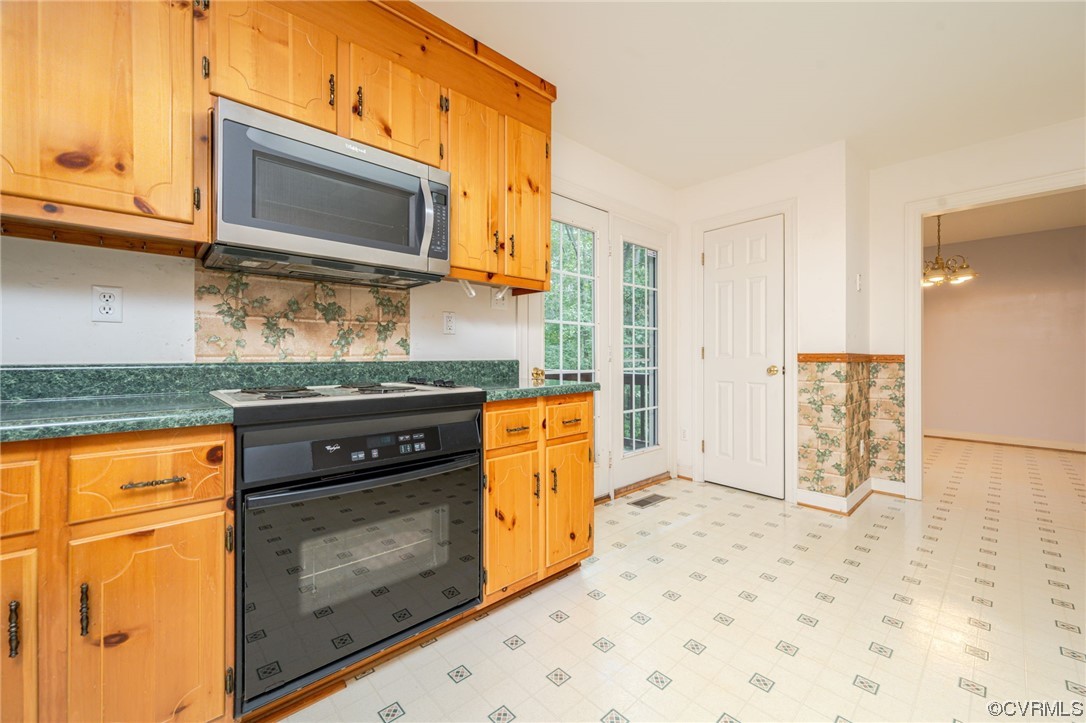 3207 Ludgate Road Chester, VA 23831 - Photo 9 of 44 a kitchen with stainless steel appliances granite countertop a stove a sink and a microwave