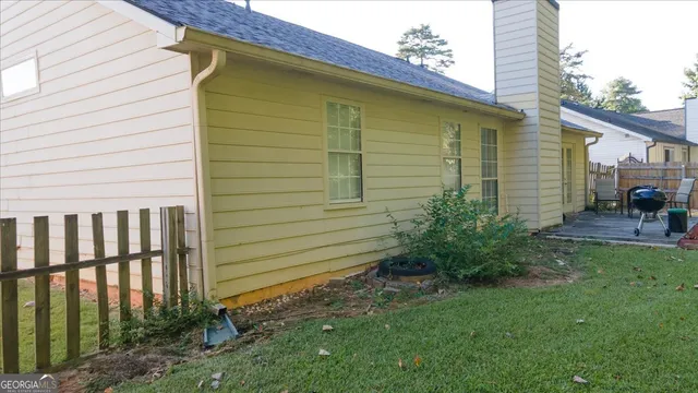 a view of a backyard with plants and a patio