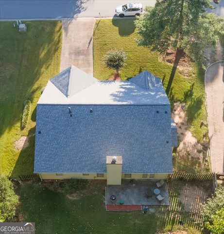 an aerial view of a house with a yard