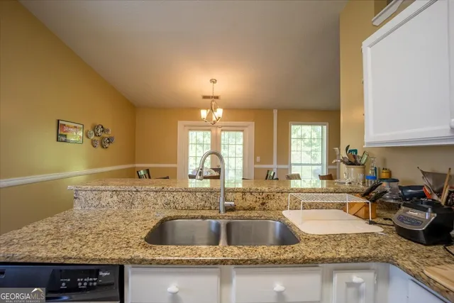 a kitchen with granite countertop a sink and a granite counter tops