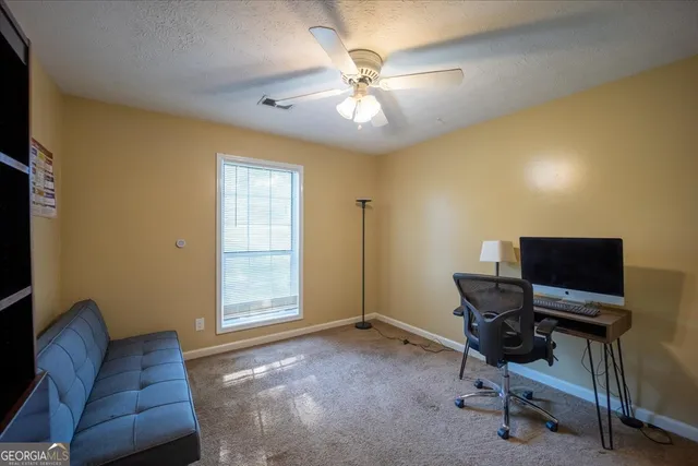 a workspace with furniture and a window