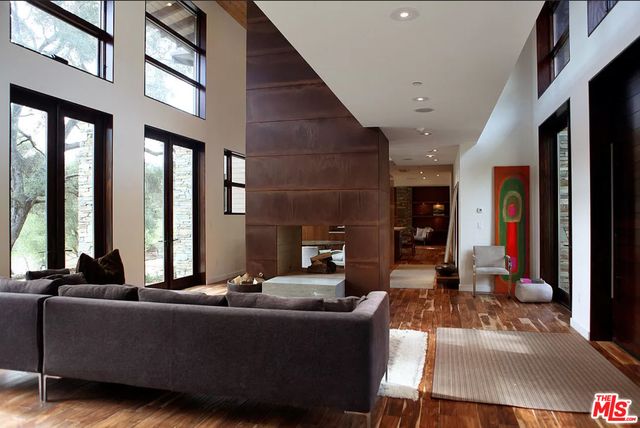 a living room with furniture and large windows