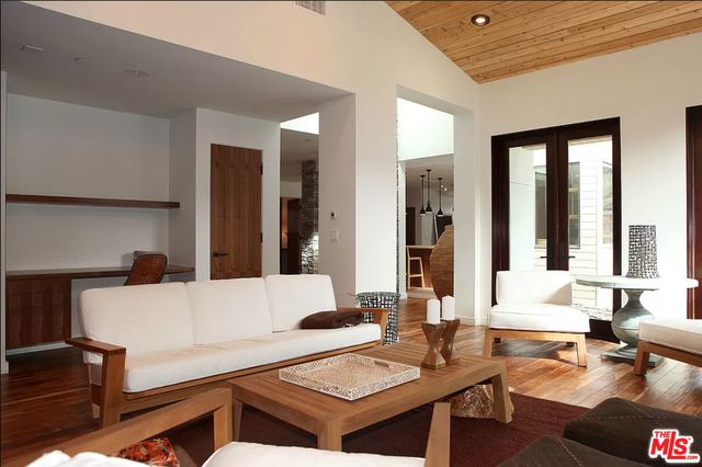 a living room with furniture and large windows