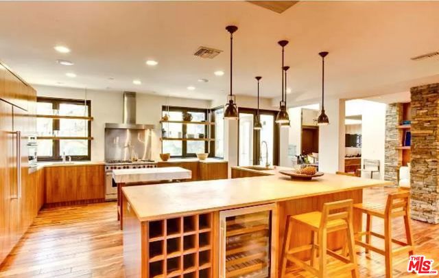 a large kitchen with kitchen island a large window