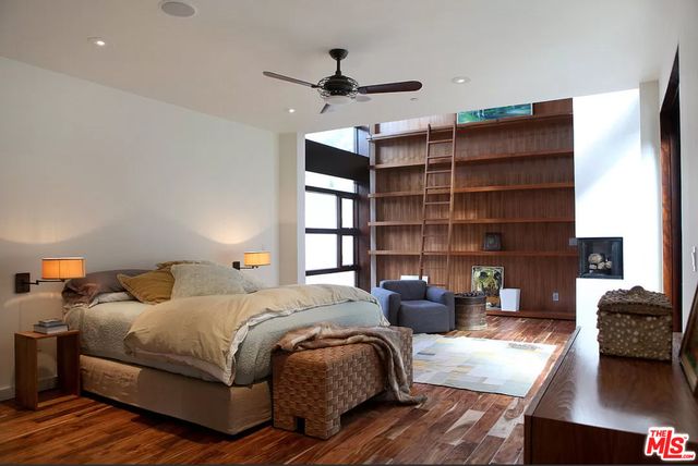 a bedroom with bed and a chandelier