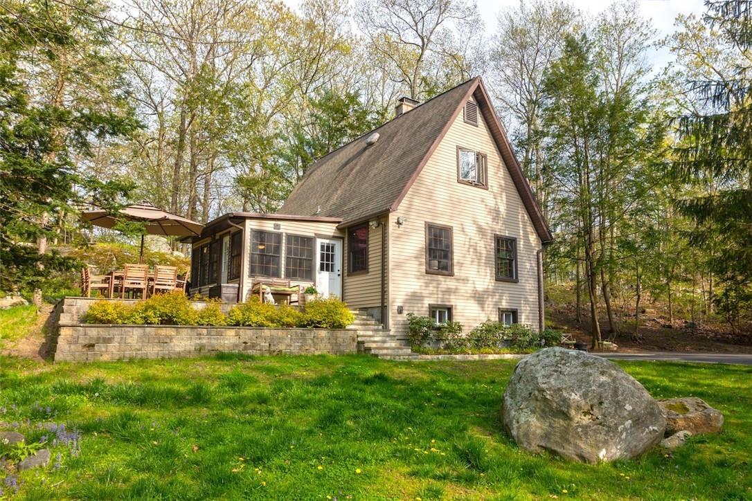 a front view of house with yard and green space