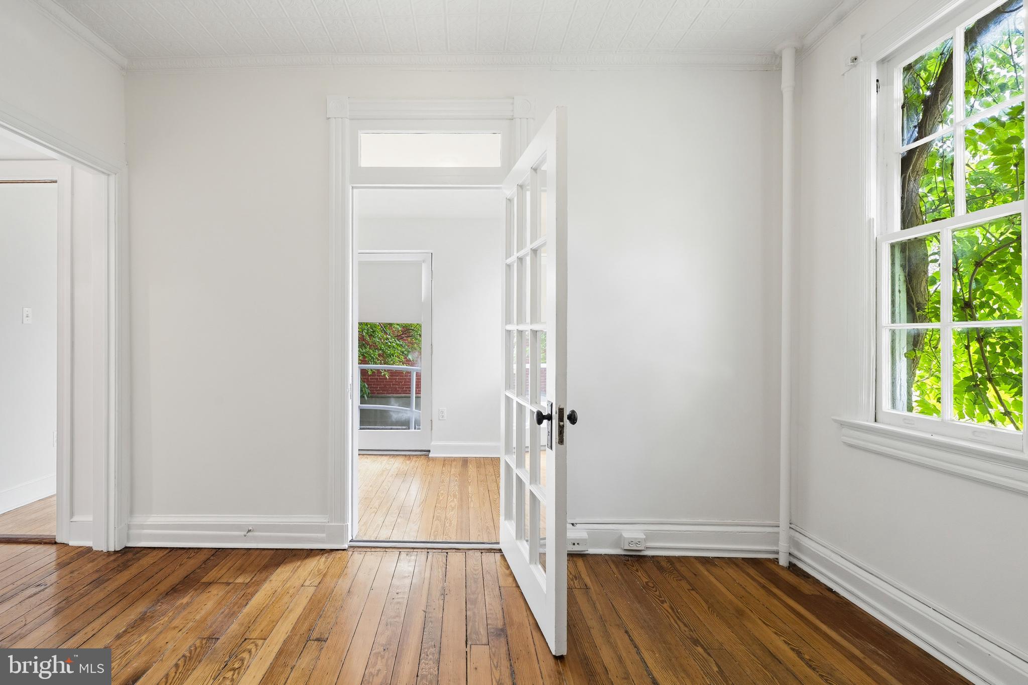 400 7th Street Southeast Washington, DC 20003 - Photo 16 of 23 an empty room with wooden floor and windows