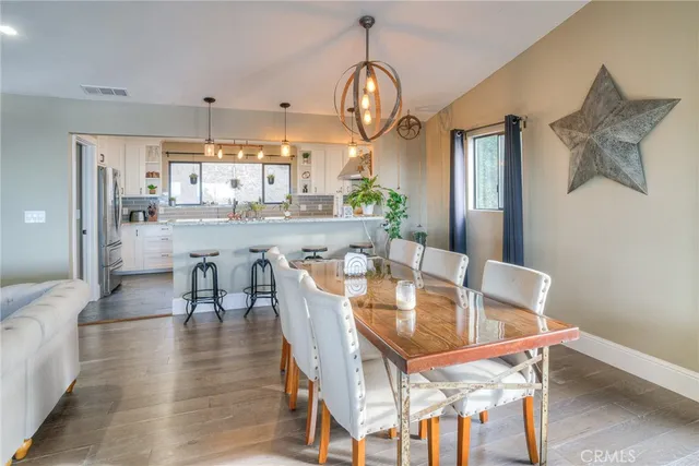 a bathroom with a granite countertop toilet sink and mirror