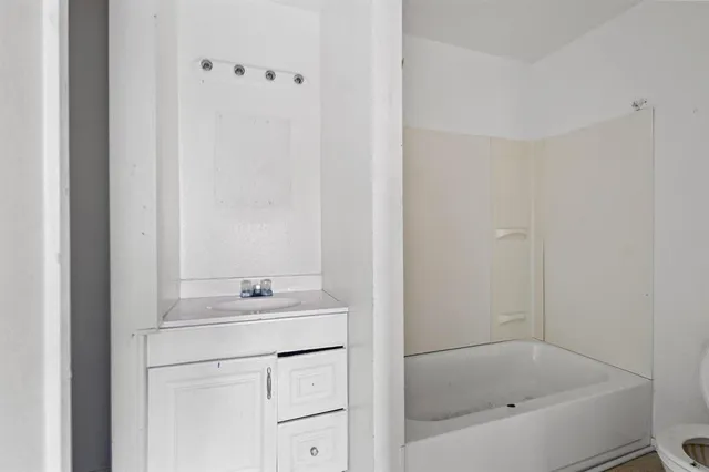 a view of a bedroom with closet and bathroom