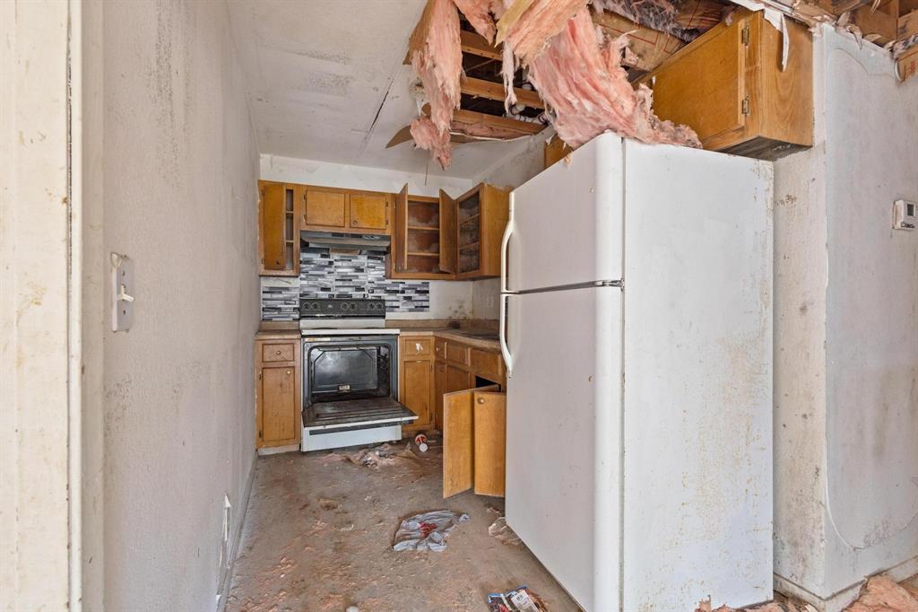 646 South Main Street Paris, TX 75460 - Photo 17 of 39 a kitchen with a refrigerator and a stove