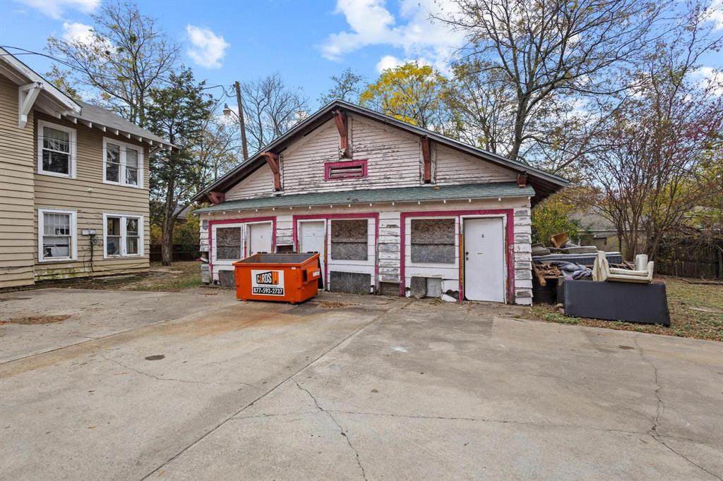 646 South Main Street Paris, TX 75460 - Photo 22 of 39 a view of a house with a yard and garage