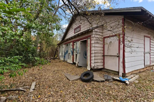 front view of a building with a tree