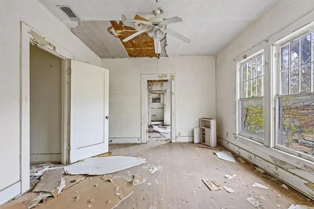 an empty room with a empty space and windows