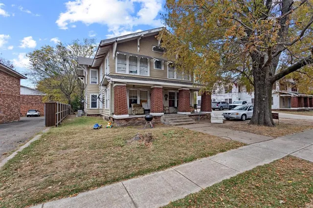 front view of a house with that has a tree