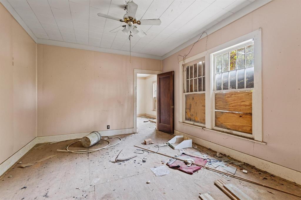 646 South Main Street Paris, TX 75460 - Photo 37 of 39 a bedroom with a bed and wooden floor
