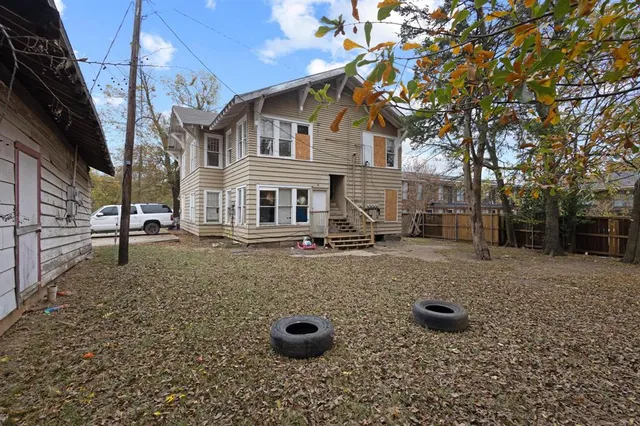 a backyard of a house with a tree