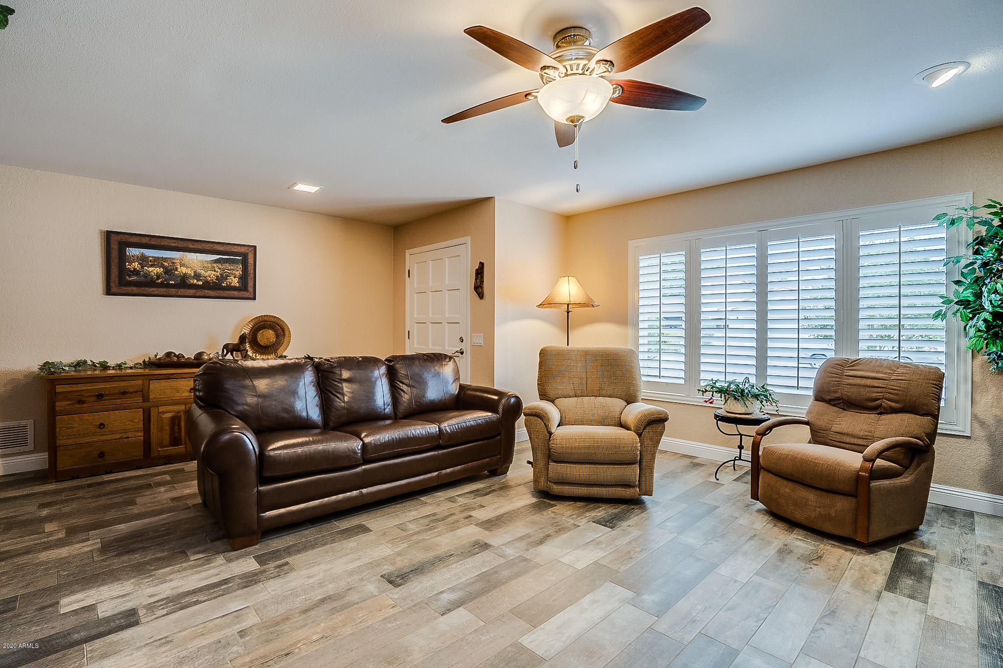 5630 South Outrigger Road Tempe, AZ 85283 - Photo 11 of 38 a living room with furniture ceiling fan and a window