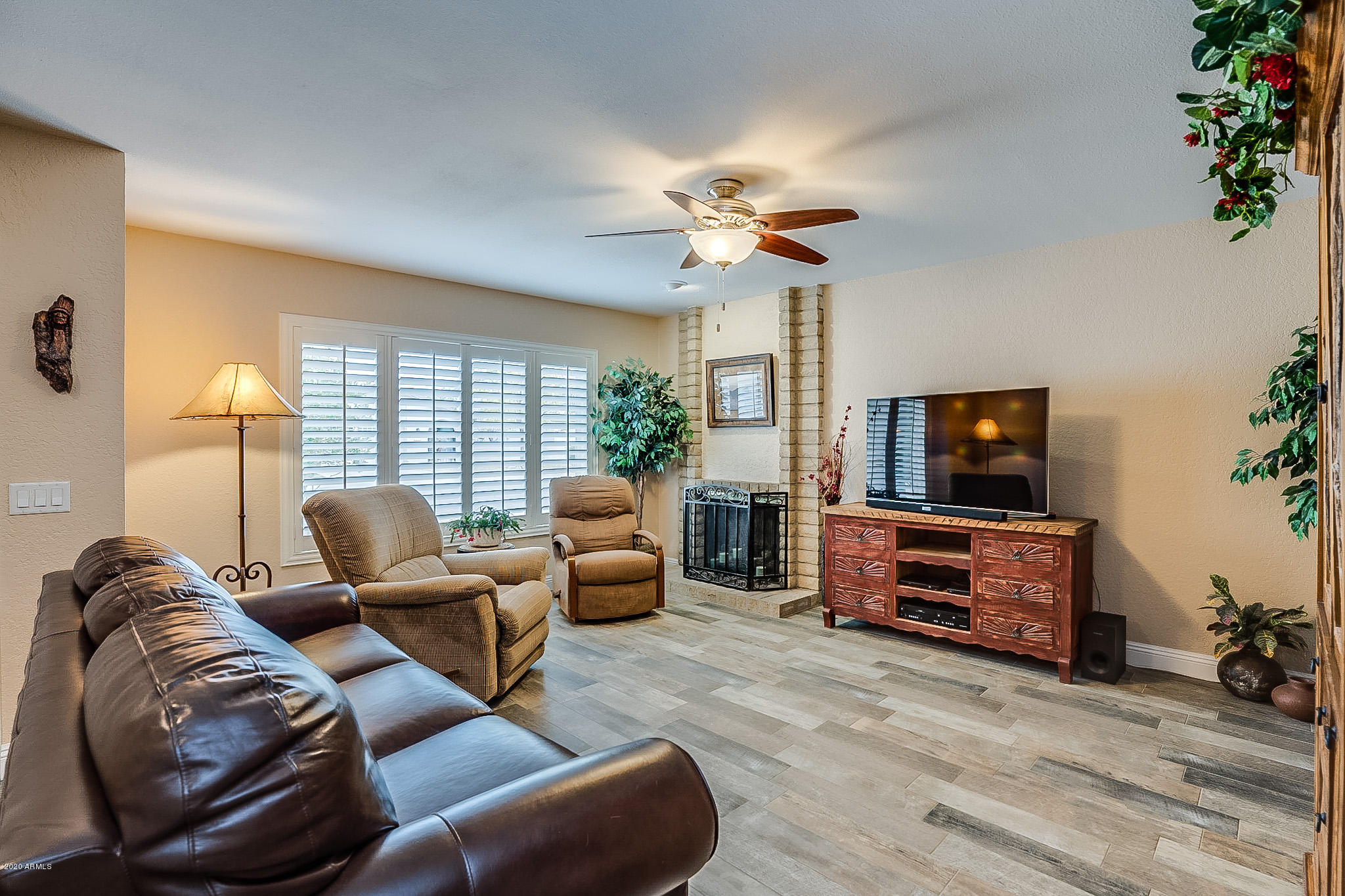 5630 South Outrigger Road Tempe, AZ 85283 - Photo 2 of 38 a living room with furniture and a flat screen tv