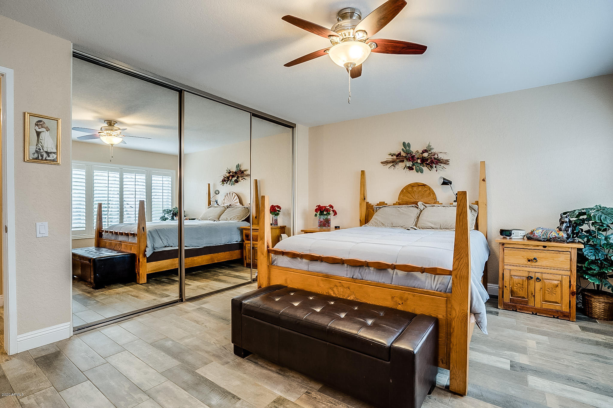 5630 South Outrigger Road Tempe, AZ 85283 - Photo 21 of 38 a bedroom with a bed and wooden floor