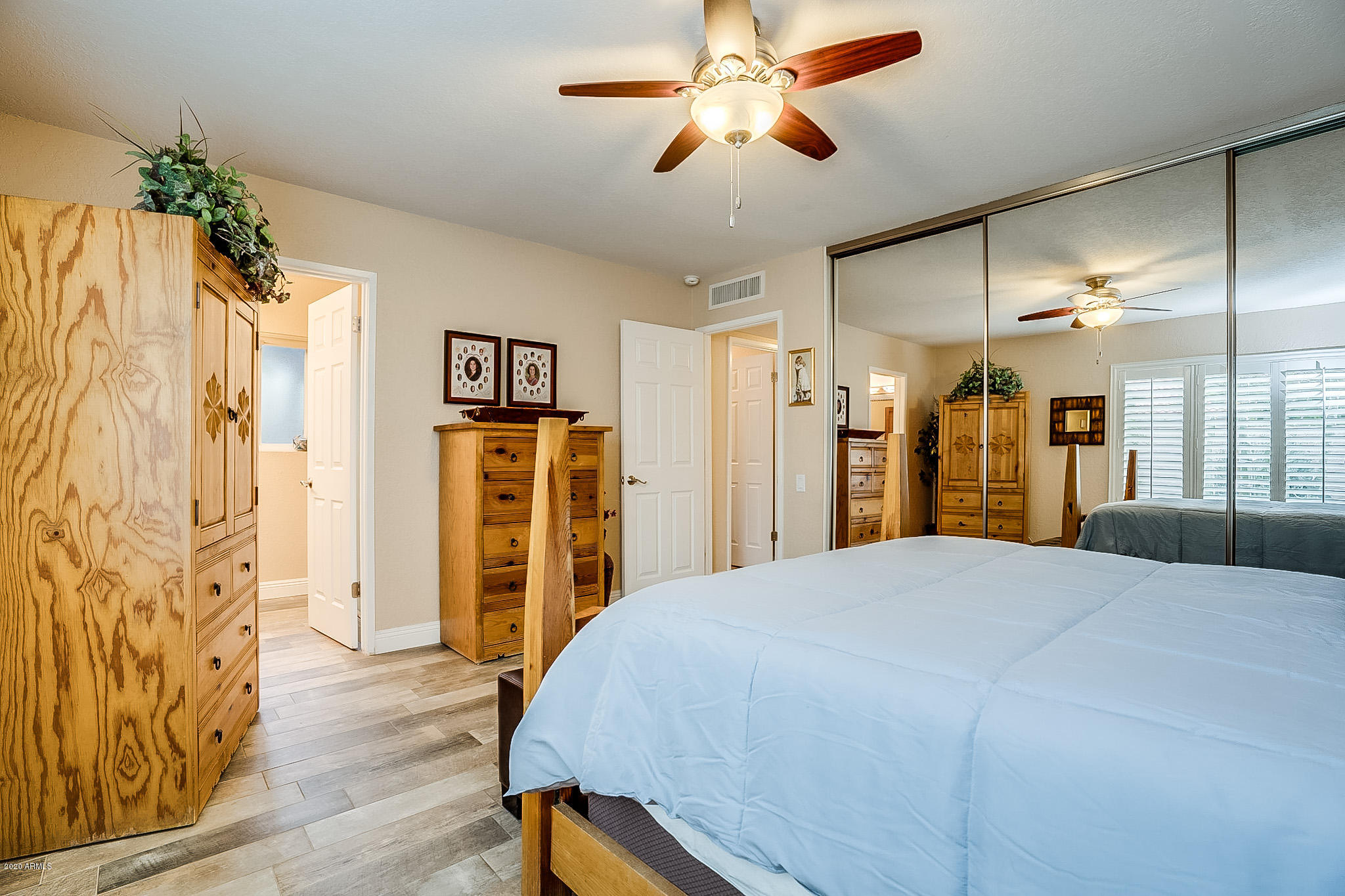5630 South Outrigger Road Tempe, AZ 85283 - Photo 23 of 38 a bedroom with a bed and a chandelier