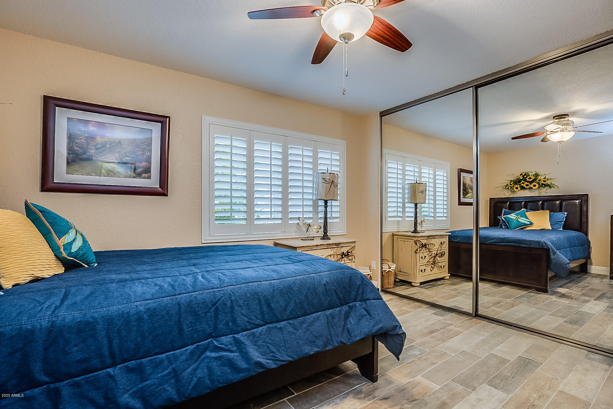 5630 South Outrigger Road Tempe, AZ 85283 - Photo 28 of 38 a bedroom with a bed and a chandelier
