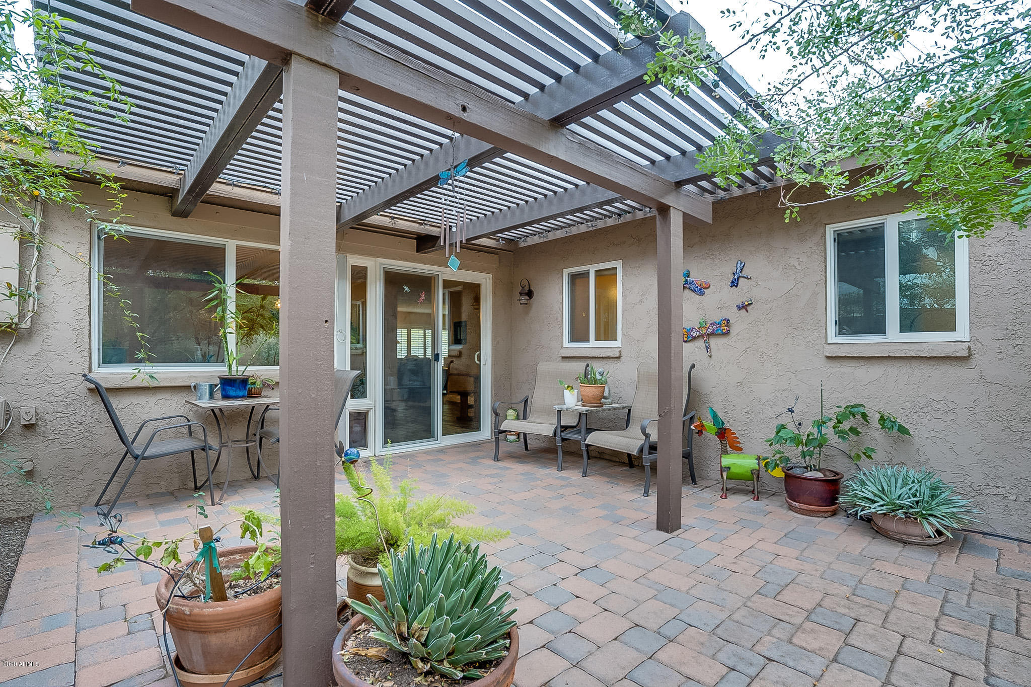 5630 South Outrigger Road Tempe, AZ 85283 - Photo 32 of 38 a front view of a house with chairs and potted plants