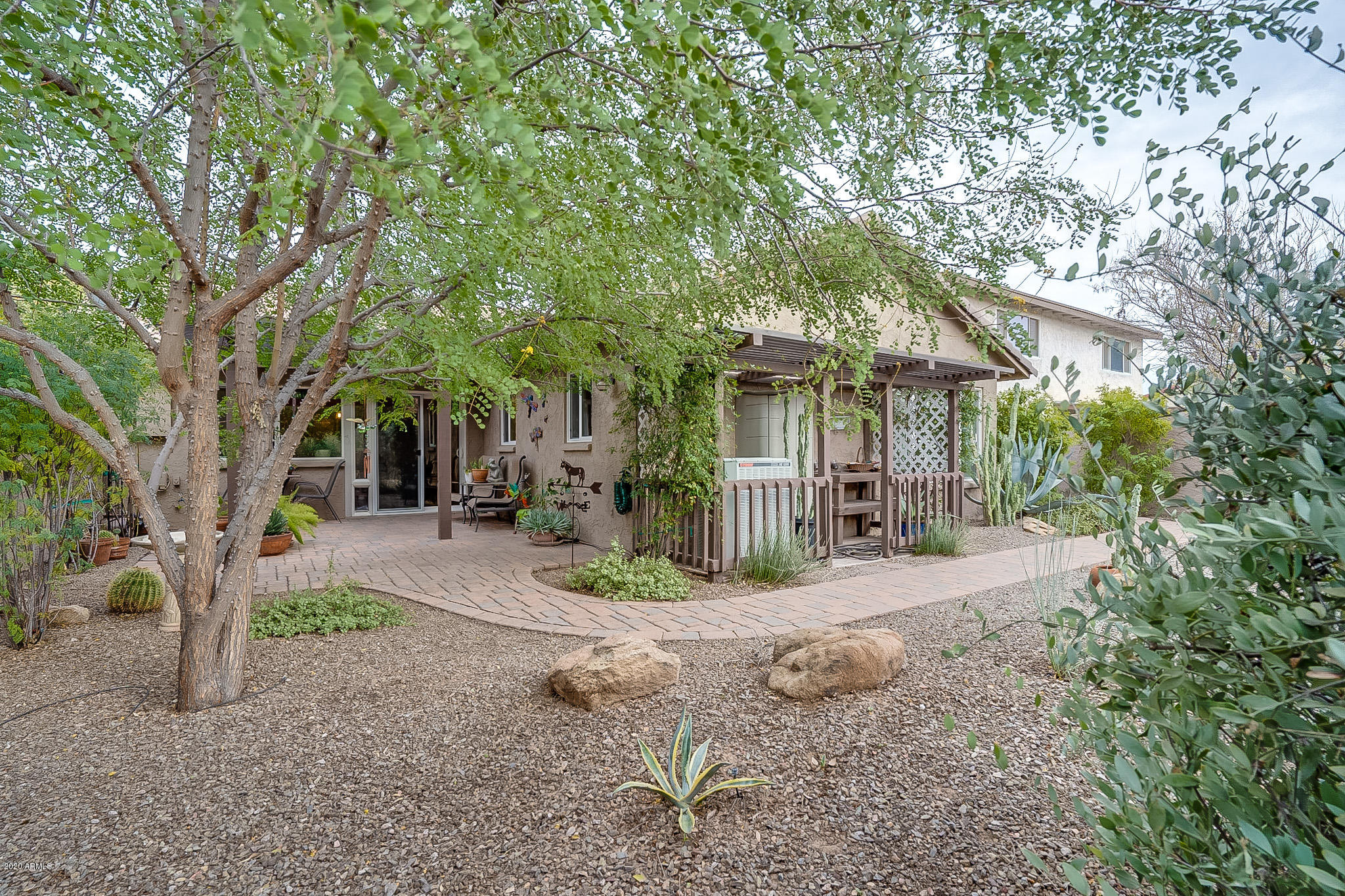 5630 South Outrigger Road Tempe, AZ 85283 - Photo 33 of 38 a front view of a house with garden and trees