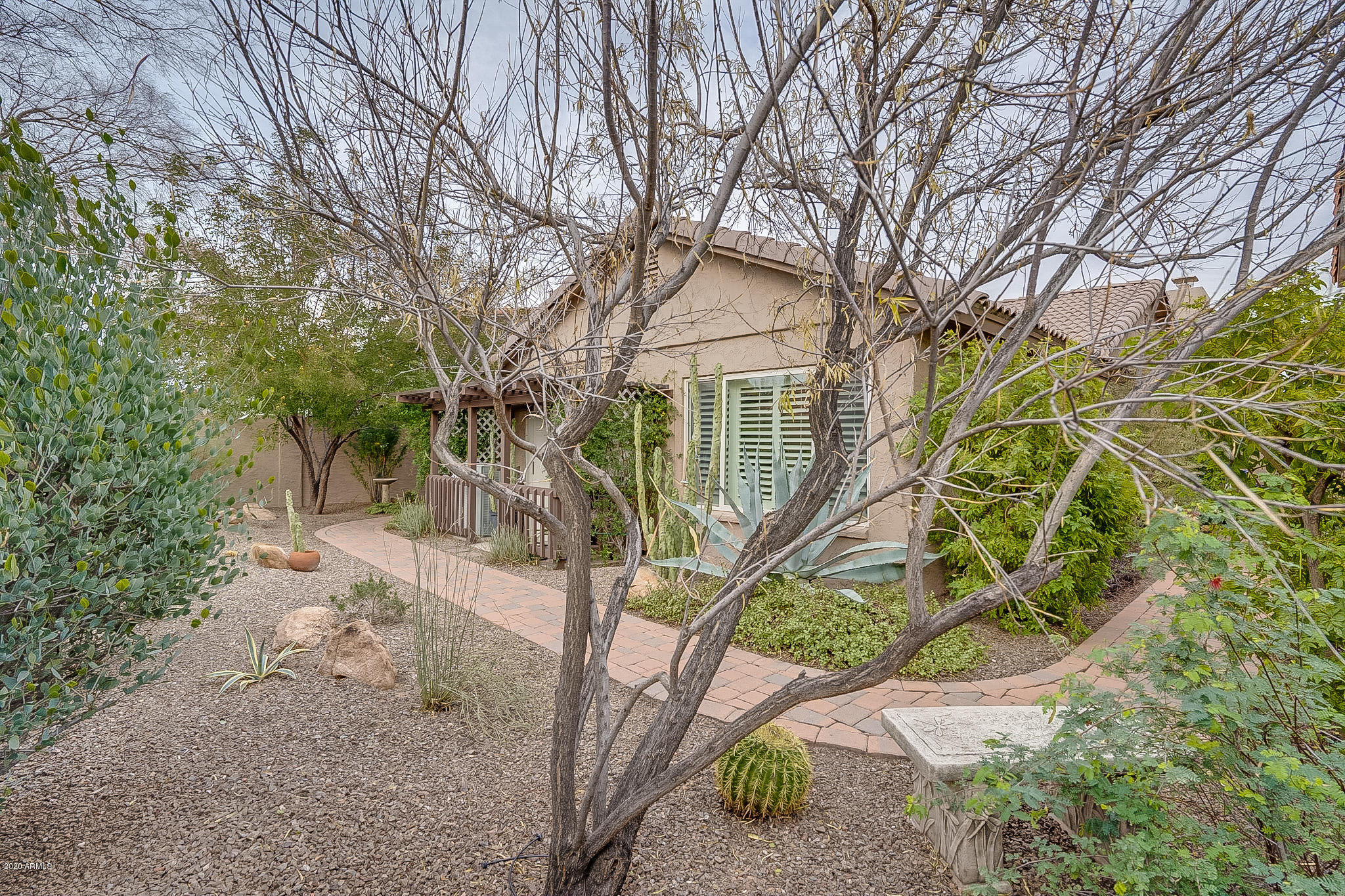5630 South Outrigger Road Tempe, AZ 85283 - Photo 35 of 38 a white house that has a tree in front of it