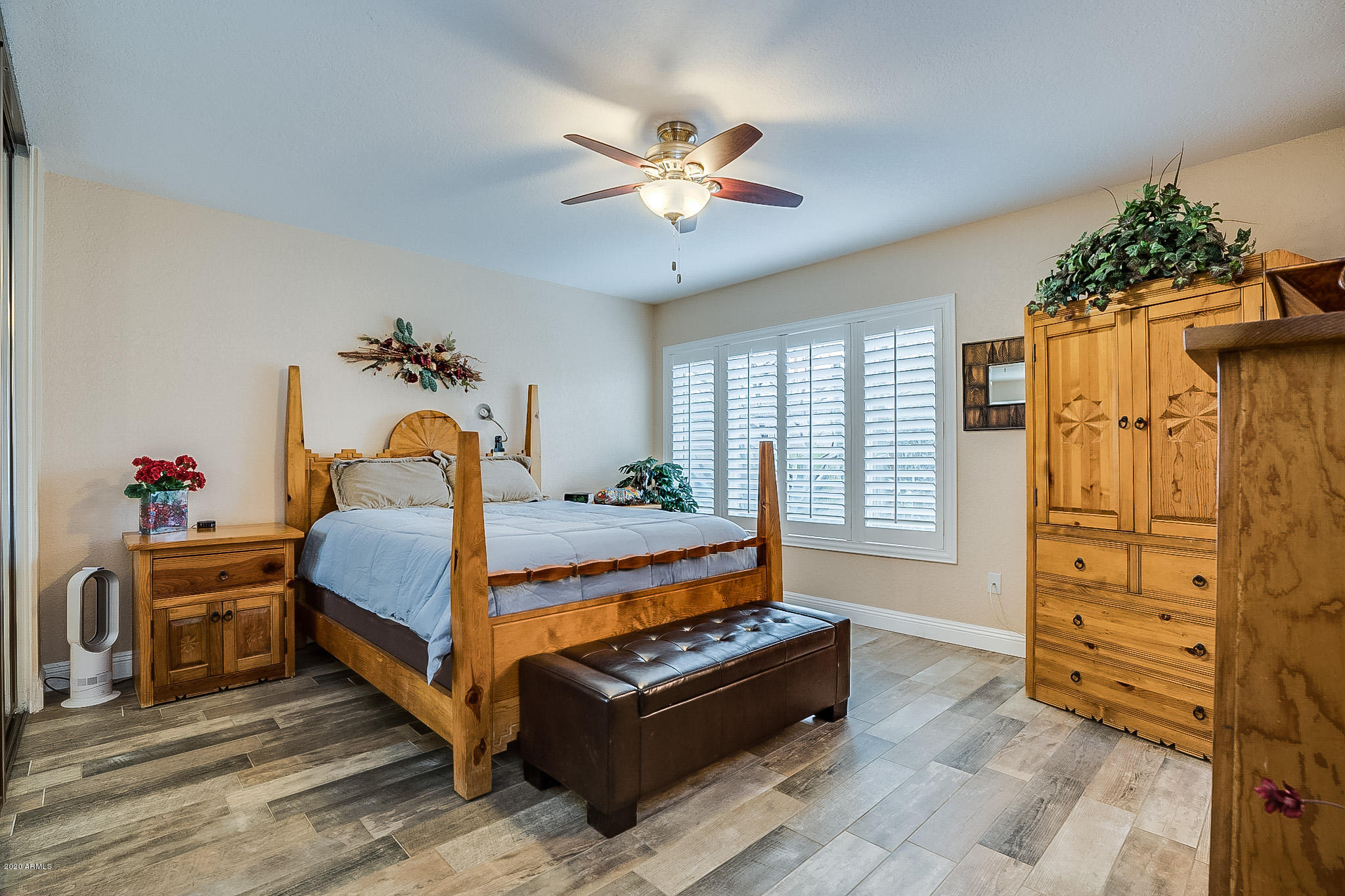 5630 South Outrigger Road Tempe, AZ 85283 - Photo 5 of 38 a bed room with a bed and a chandelier