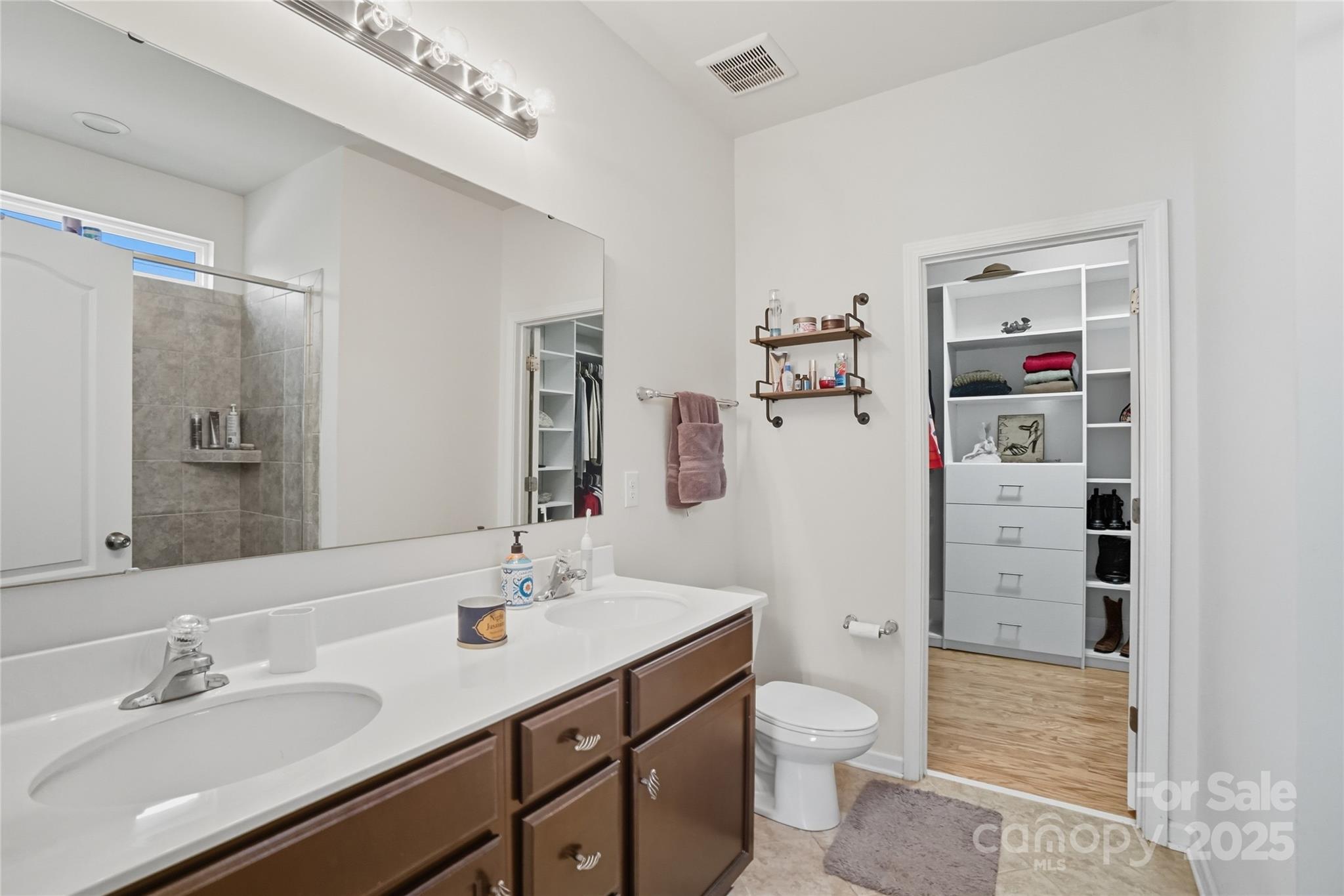 134 East Neel Ranch Road, Unit 13 Mooresville, NC 28115 - Photo 11 of 20 a bathroom with a double vanity sink toilet and shower