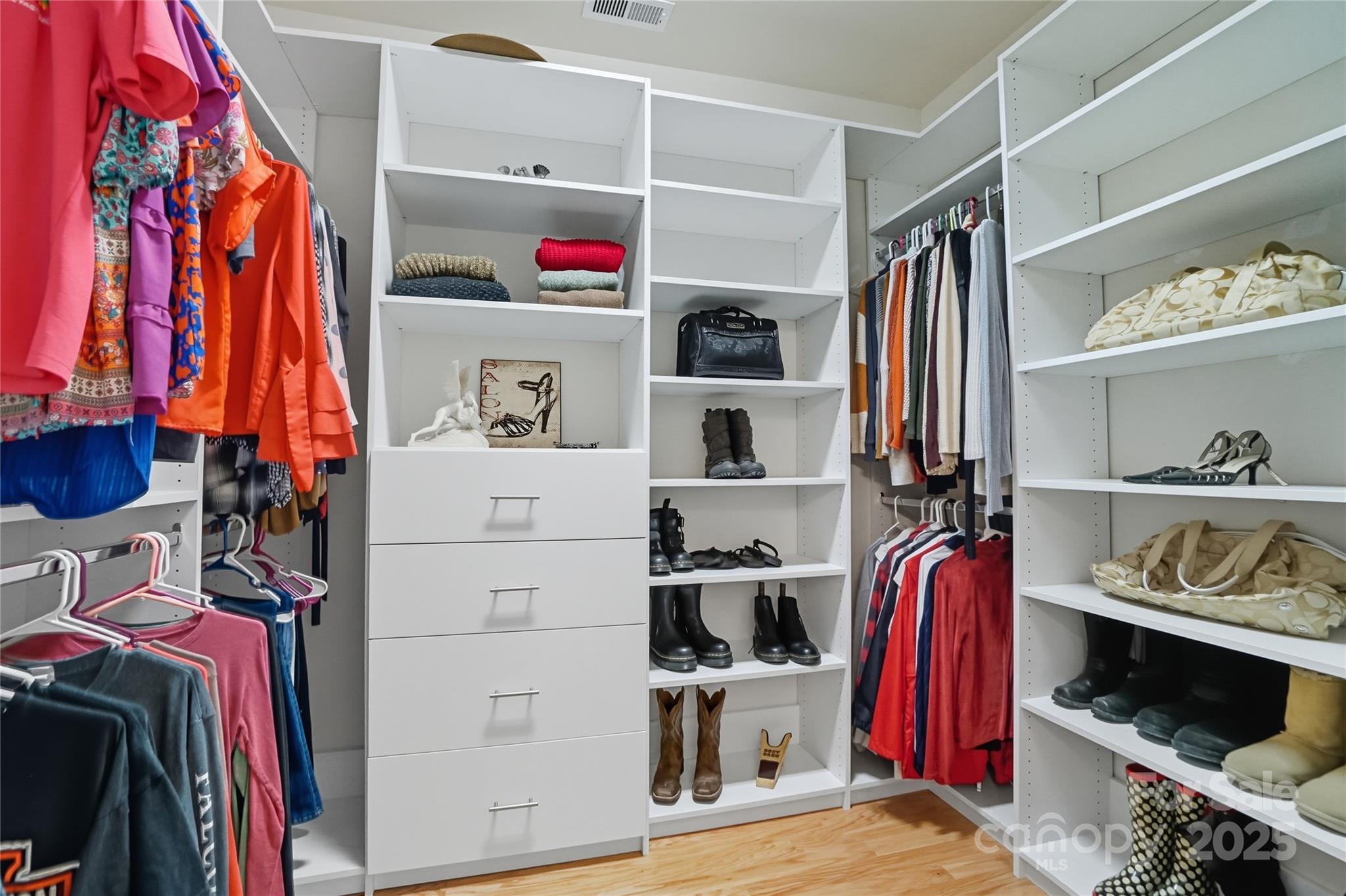 134 East Neel Ranch Road, Unit 13 Mooresville, NC 28115 - Photo 12 of 20 a view of walk in closet with clothes and shoes