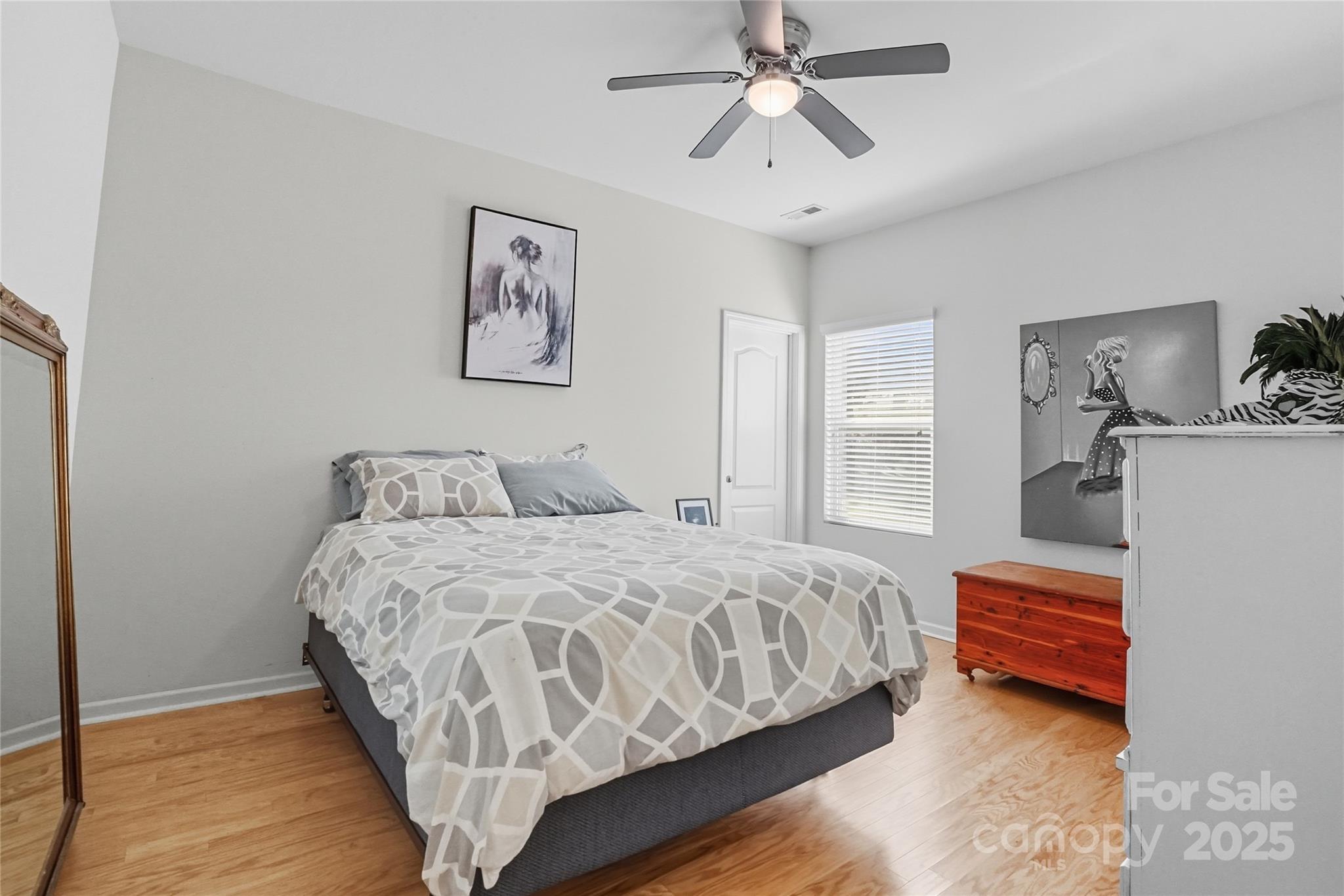134 East Neel Ranch Road, Unit 13 Mooresville, NC 28115 - Photo 14 of 20 a bedroom with a bed and wooden floor