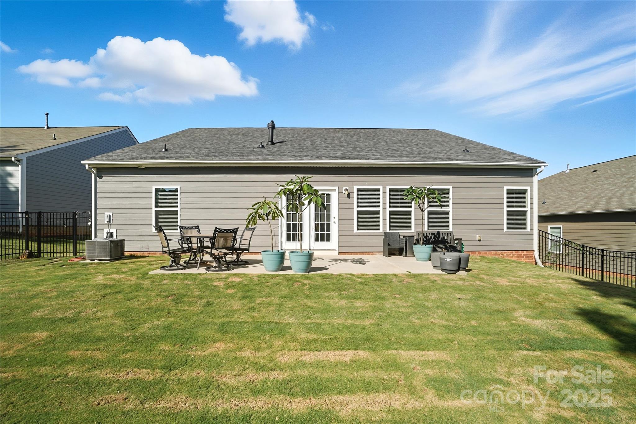 134 East Neel Ranch Road, Unit 13 Mooresville, NC 28115 - Photo 20 of 20 a view of a house with a patio and a yard