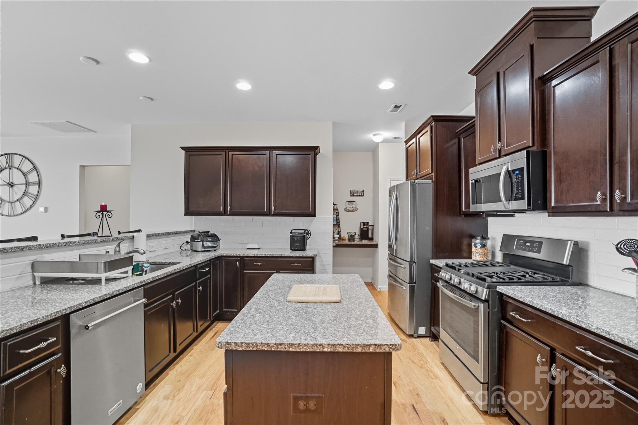134 East Neel Ranch Road, Unit 13 Mooresville, NC 28115 - Photo 6 of 20 a kitchen with stainless steel appliances granite countertop a sink stove and refrigerator