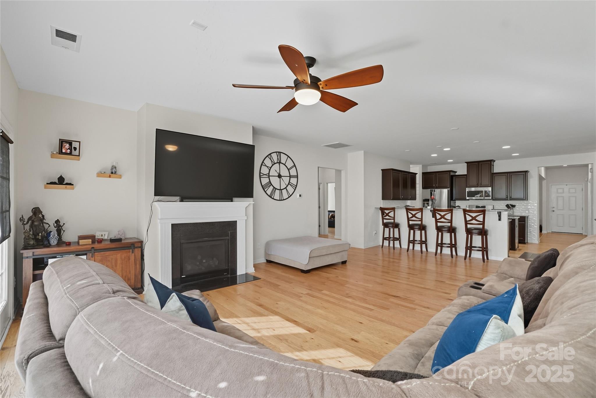 134 East Neel Ranch Road, Unit 13 Mooresville, NC 28115 - Photo 7 of 20 a living room with furniture a fireplace and a flat screen tv