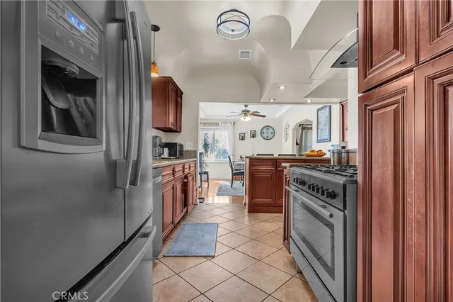 a kitchen with stainless steel appliances granite countertop a stove and a refrigerator