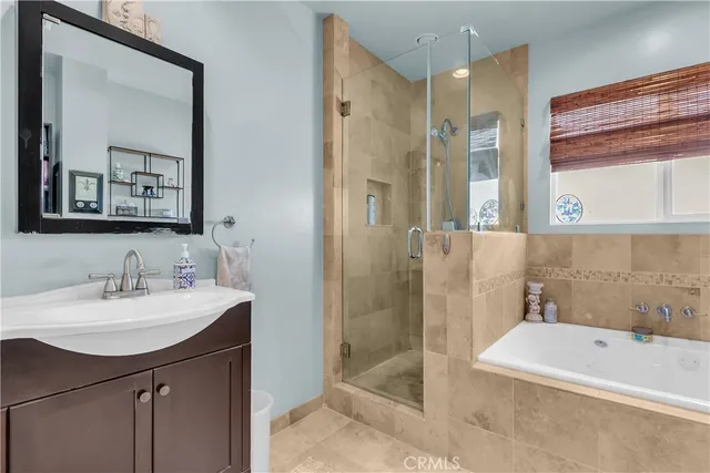 a bathroom with a tub sink and mirror